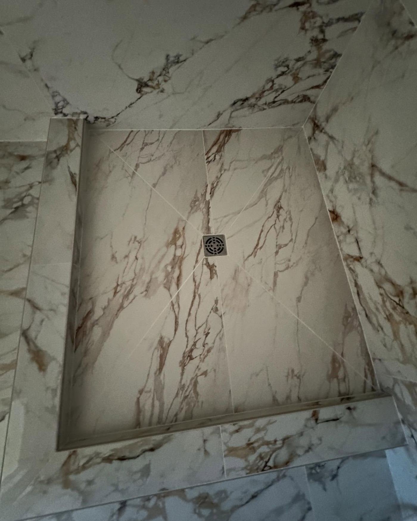 Large-format marble slab shower niche