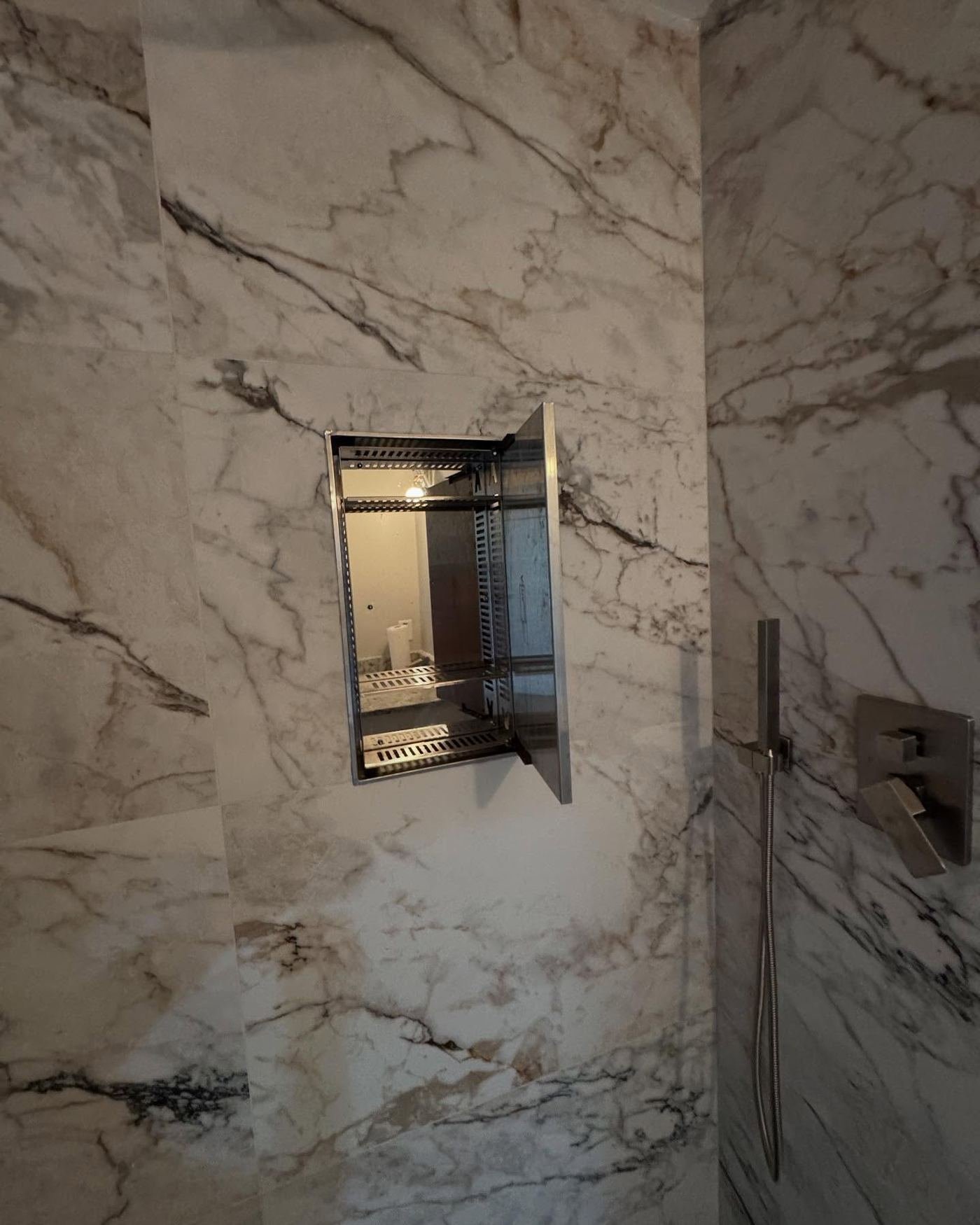 Marble slab shower niche detail installed by Hands of Freedom