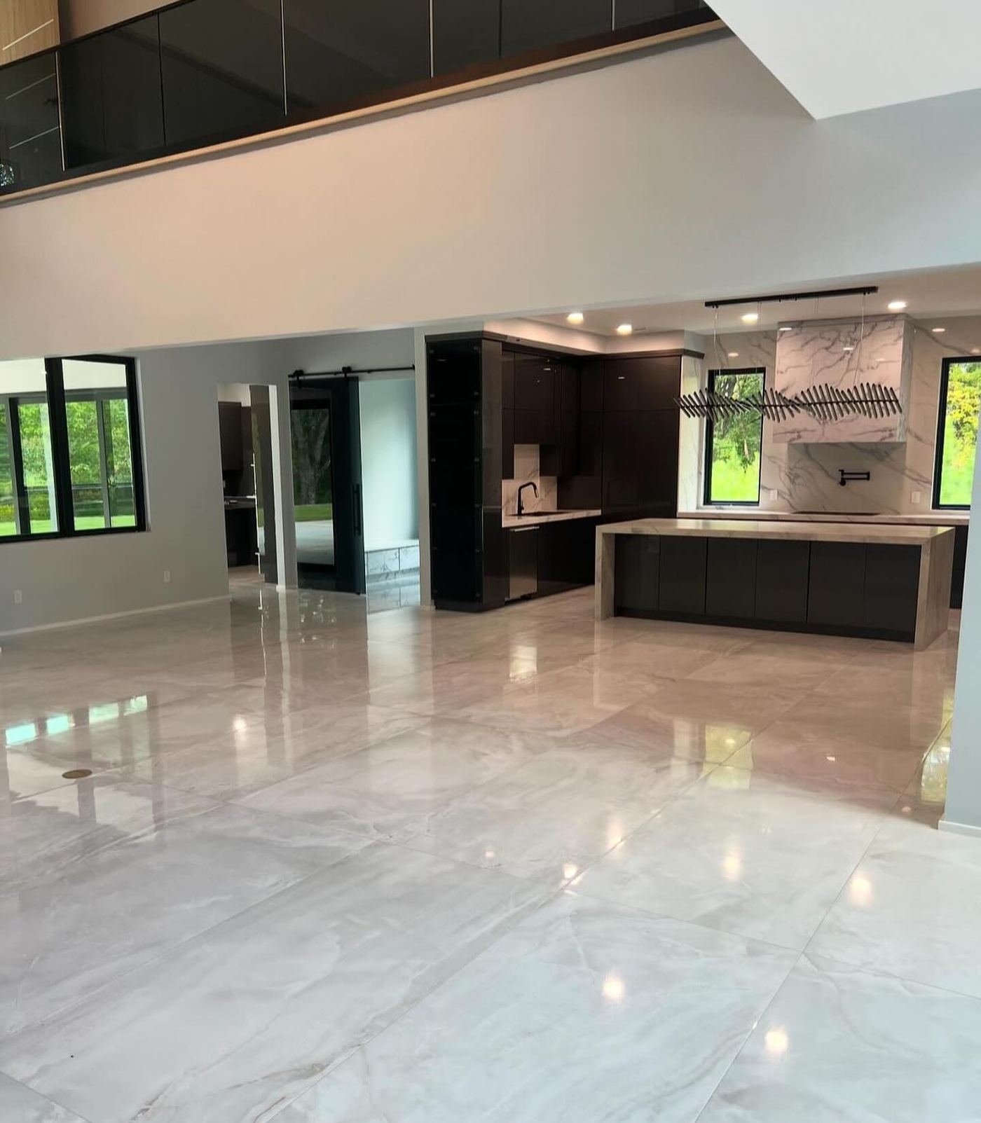 Open-plan living space with large-format marble flooring