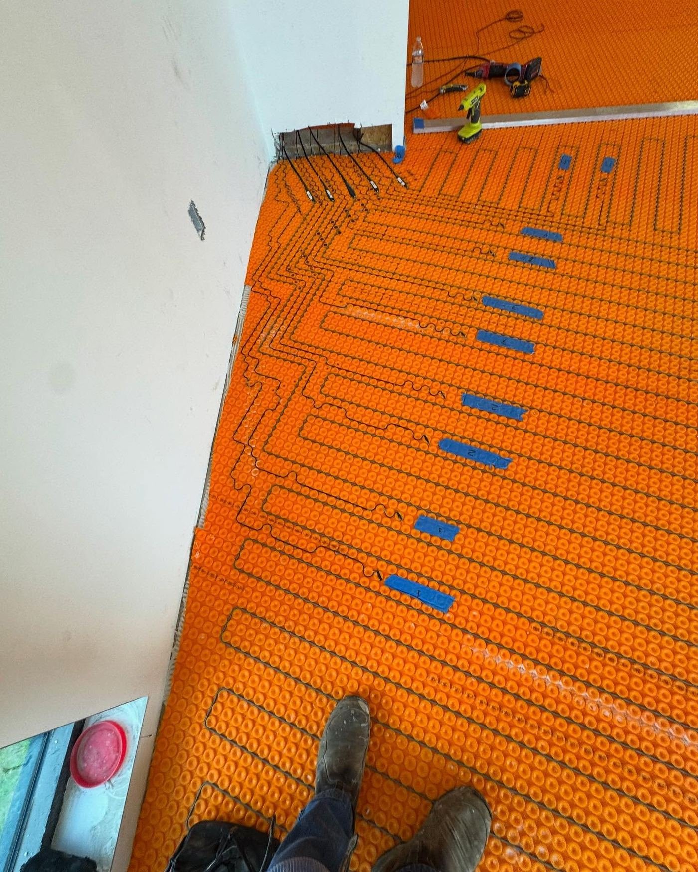 Organized jobsite with Ditra-Heat uncoupling membrane installed