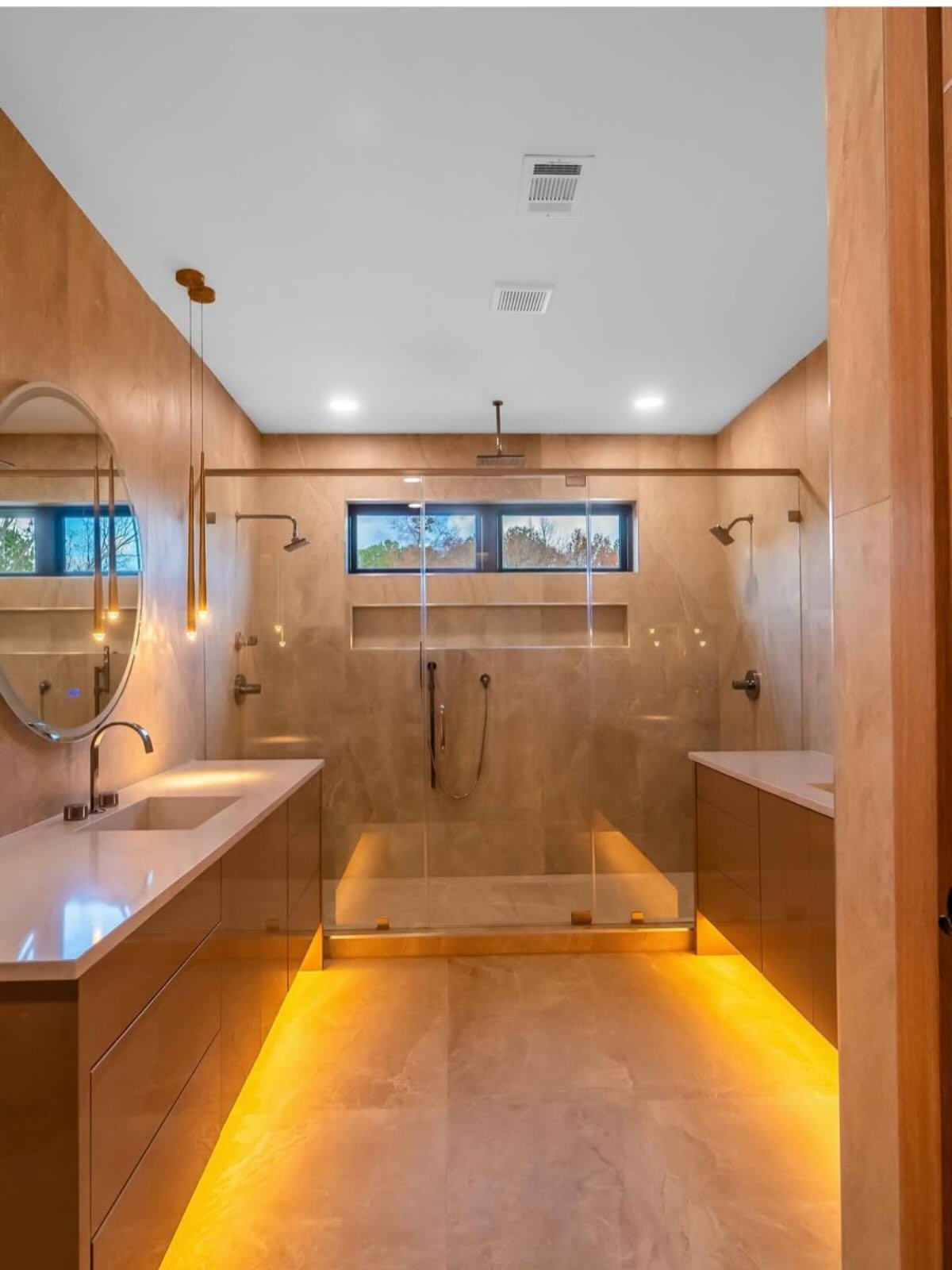 Warm-lit bathroom with radiant heated tile floor